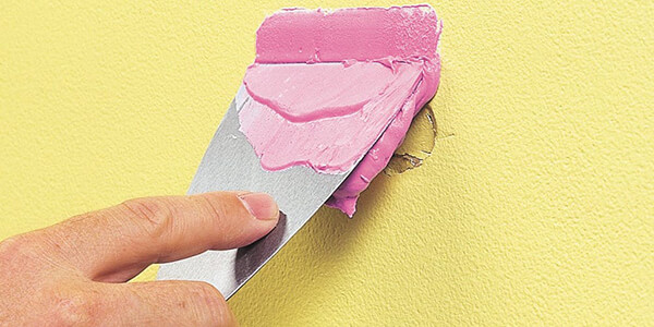 Apply Spackle Using Putty Knife on nail hole Apply Spackle Using Putty Knife on nail hole