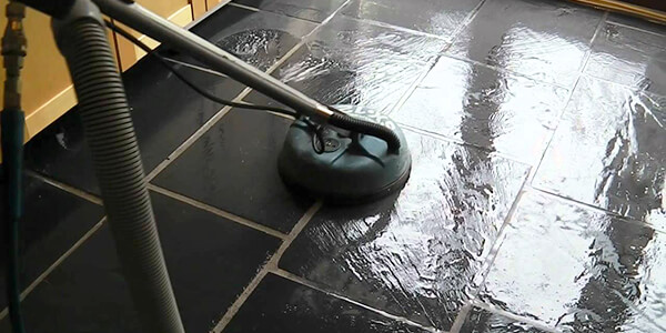 Cleaning the slate tile floor bya a vacuum cleanner Cleaning the slate tile floor bya a vacuum cleanner