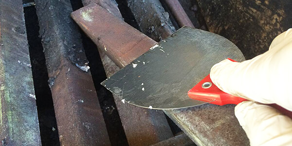 Scrap the grease with putty knife Scrap the grease with putty knife